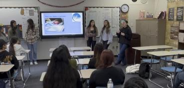 Students presenting in front of class